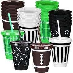 a group of different colored cups with straws on top of each cup, all decorated in black and white stripes