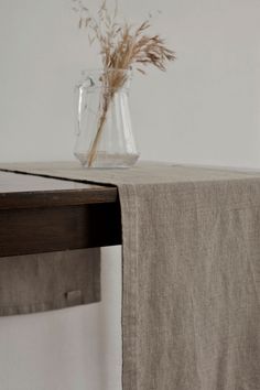 a vase with some flowers in it sitting on a table