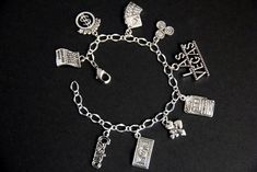 "A collection of silver plated Las Vegas themed charms have been dispersed around a shimmering silver plated bracelet chain in this handmade charm bracelet. This Las Vegas charm bracelet is then completed with a lobster clasp and a 1/2 inch of chain at the end for adjustable sizing. Charms in this bracelet include a hand of cards charm, \"casino\" word charm, 100 dollar bill charm, Las Vegas sign charm, card suits charm, lottery ticket charm, poker chips charm, jackpot charm, and a slot machine Personalized Themed Silver Bracelets, Themed Silver Bracelets With Charms, Themed Silver Jewelry With Charms, Symbolic Silver Hypoallergenic Charm Bracelet, Silver Symbolic Charm Bracelet Hypoallergenic, Themed Silver Charm Bracelet, Silver Costume Jewelry Charm Bracelet With Vintage Charm, Silver Retro Charm Bracelet, Sterling Silver Dangle Charm Bracelet With Vintage Charm