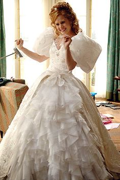 a woman in a wedding dress holding an umbrella