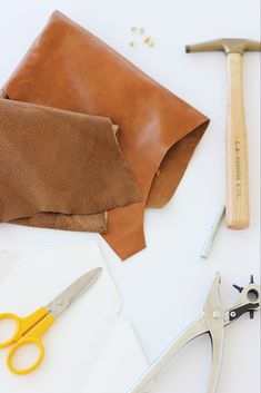 the tools needed to make this diy leather purse