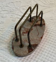 a marble and metal object sitting on top of a bed