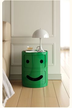 a green side table with a lamp on top and a smiley face drawn on it