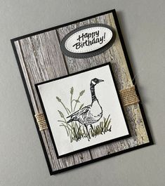 a happy birthday card with a duck and grass on the front, saying happy birthday