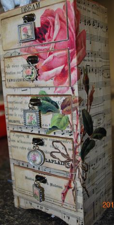 a wooden box with flowers painted on it