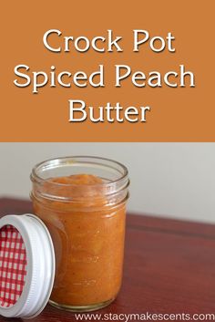 a jar filled with spiced peach butter sitting on top of a wooden table next to a