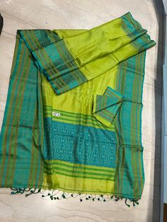 This is a creation of the master weavers of Bengal , Fulia . This saree is made of pure gachhi by gachhi  tussar and the border and  pallu is pure silk  . Very easy to carry it . The colour has an  unique combinations .  Saree comes with a running blouse piece .  As it is entirely handmade so some irregularities is the mark of originality of handloom product.  With Silk mark certificate of India Government .  Fall and pico , tassel done and complimentary .  Note : Please leave your phone no and email id for shipping purpose. Transitional Green Pre-draped Saree With Self Design, Green Raw Silk Pre-draped Saree With Self Design, Green Handloom Chanderi Pre-draped Saree, Semi-stitched Slub Silk Handloom Saree, Traditional Green Slub Silk Pre-draped Saree, Green Cotton Silk Traditional Wear For Ceremonies, Diwali Slub Silk Pre-draped Saree With Weaving Work, Multicolor Slub Silk Saree With Weaving Work, Handloom Tussar Silk Saree Sets