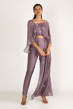 Dusted mauve lilac layered cape top with placement floral motif work. Comes with draped pants.
Component: 2
Embroidered
Sleeve Length: Sleeveless
Fabric: Dupion, Tabi silk, Shantoon
Color: Purple
Layered top
Cape-style
Draped pants - Aza Fashions Peacock Couture, Cape Top, Embroidered Jumpsuit, Cape Tops, Drape Pants, Dusty Mauve, Pink Peacock, Cape Style, Embroidered Pants