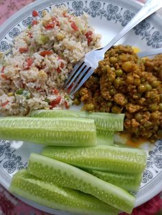 a white plate topped with rice, celery and beans