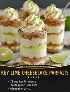 key lime cheesecake parfaits in small glass jars with limes around them