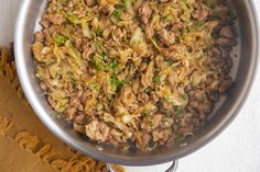 a pan filled with meat and vegetables on top of a table