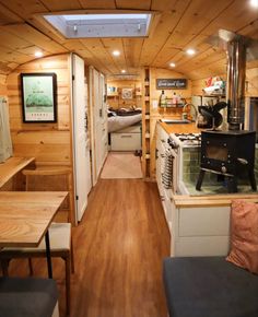 the interior of a tiny home with wood paneling and wooden flooring on both sides