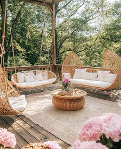 a porch with wicker furniture and pink flowers