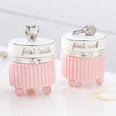 two pink toothbrush holders sitting on top of a white table next to each other