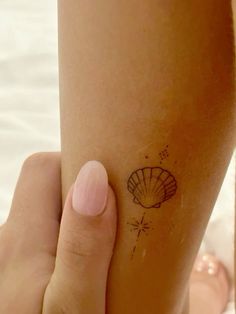 a woman's foot with a small tattoo on the side of her left leg