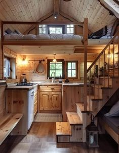 the interior of a tiny cabin with stairs