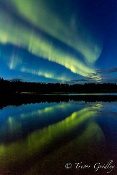 an aurora bore is reflected in the water