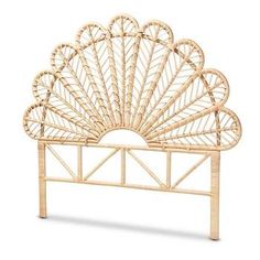 a wicker headboard with an intricate design on the top and bottom part of it