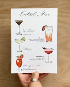 a hand holding up a card with cocktails on it and the names of each drink