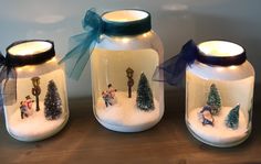 three glass jars with christmas decorations in them