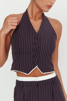 Halter neck pinstripe vest Front button closure Lined Set-matching pants Elevate your wardrobe with our Lilija vest- where classic tailoring meets contemporary flair. Featuring a classy halter neck, this top adds a modern twist to traditional suiting. Whether you're commanding the boardroom or enjoying brunch with friends, it is the perfect choice for chic sophistication. Pair it with it's matching pant or mix and match for endless possibilities! MODEL INFO Model is wearing size XS Height: 5'10" Halter Neck Vest, Pinstripe Vest, Classic Tailoring, Yellow Bridesmaid Dresses, Purple Bridesmaids, Yellow Bridesmaids, Red Bridesmaids, Veil Hairstyles, Lace Bodycon Dress