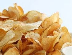 a pile of potato chips sitting on top of a white plate