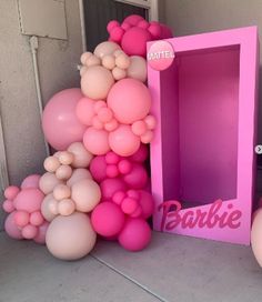 there is a pink box with balloons all over it