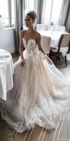 a woman in a wedding dress sitting at a table