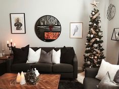 a living room filled with furniture and a christmas tree in front of a wall clock