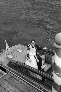 black and white photo of bride and groom on boat