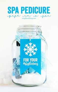 a glass jar filled with snowflakes and a sign that says for your mistleties