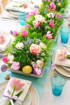 the table is set with flowers and plates