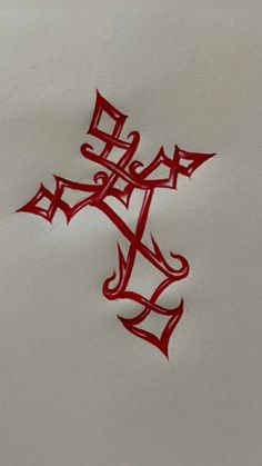 the cross is drawn in red ink on white paper