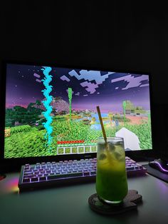 a drink sitting in front of a computer screen