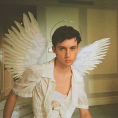 a young man with white wings on his head