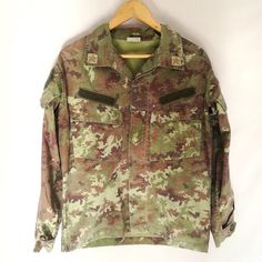 - Italian Army Field Shirt or jacket / shacket - Vegetato Camo pattern on Rip Stop cotton fabric - One inner pocket with zip - Lots of outer pockets on the front and the sleeves - Ventilated, open areas under the arms - Slightly tailored towards the waist, V-shape - This is a relatively lightweight jacket or heavyweight shirt - classic shacket. Perfect for Spring or Autumn/Fall, good for layering. Condition: Vintage condition with heavy signs of wear: the edges of the sleeves and hems are frayed Ive Got This, Italian Army, Army Jacket, Strong Colors, Lightweight Jacket, V Shape, Camouflage, Camo, Mens Jackets