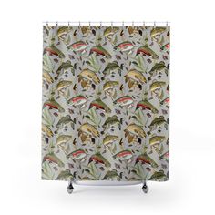 a shower curtain with an image of birds and flowers on the back of it,