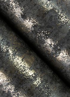 an old black and gold textured fabric with metallic flecks on the surface