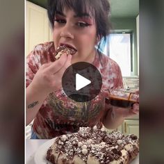 a woman eating food while sitting in front of a cake on a plate with chocolate frosting