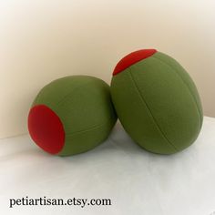 two green and red balls sitting next to each other