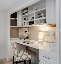 a white desk with a chair next to it and some shelves on the wall behind it