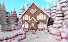 a gingerbread house with pink and white decorations in the snow next to some trees