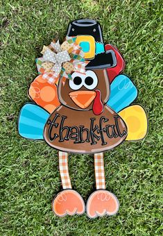 a turkey with a hat and bow on it's head is standing in the grass