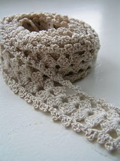 a crocheted white ribbon on a table