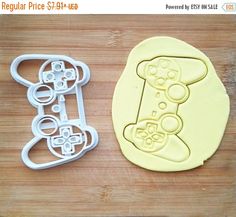 two cookie cutters sitting next to each other on a cutting board with the same design