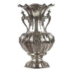 an ornate silver vase is shown on a white background