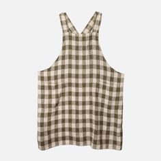 a white and black checkered tank top with straps on the back, in front of a