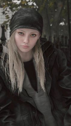 a woman with long blonde hair wearing a black jacket and beanie sitting on a bench