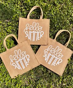 three burlap bags with the words hello summer on them sitting in some grass