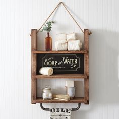 a wooden shelf with soap and water on it